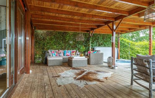 a covered patio with a couch and a table at Nice Home In Erm With Wifi in Erm