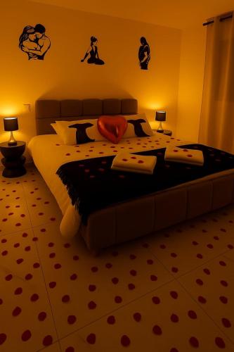 a bedroom with a large bed with two lamps at Love Room Royan in Royan