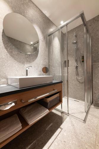 a bathroom with a sink and a shower at Hotel Untersberg in Sankt Leonhard