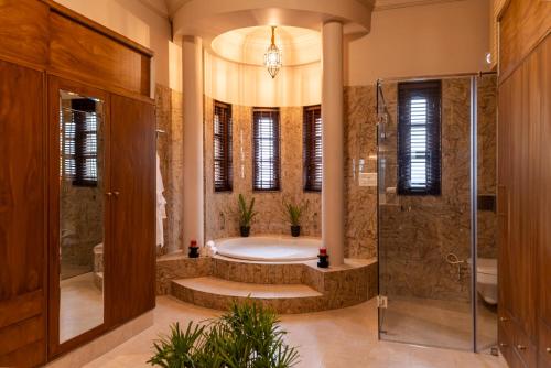 a large bathroom with a tub and a shower at Villa Sol- A Hilltop Villa in Udaipur in Jāmb