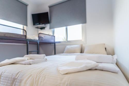 a bedroom with two beds with white towels on them at Black Swan Villa in Pervolia