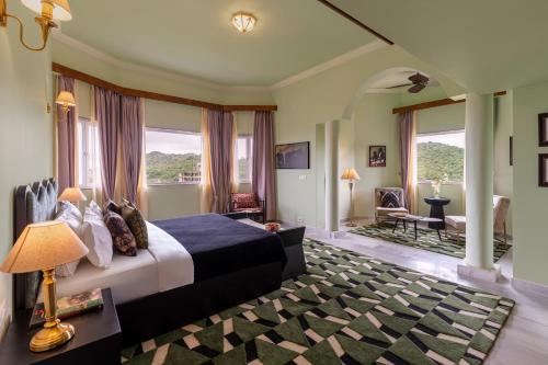 a bedroom with a bed and a living room at Villa Sol- A Hilltop Villa in Udaipur in Jāmb