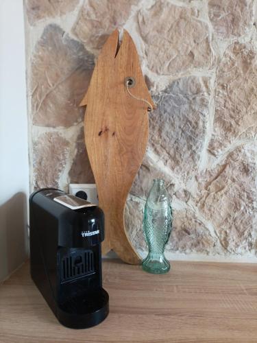 a wooden bird head next to a toaster and a vase at Mediterranean apartment with home theater in Bodegraven