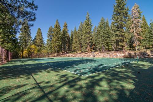 a tennis court with trees in the background at The Kingswood Retreat in Kings Beach