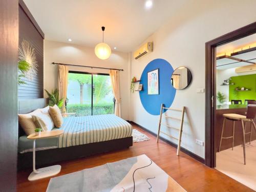 a bedroom with a bed and a living room at MYSA House Pool Villa Central Phuket in Phuket