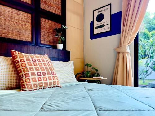 a bedroom with a bed and a window at MYSA House Pool Villa Central Phuket in Phuket
