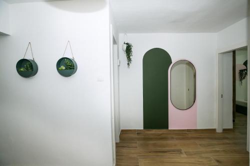 a living room with a mirror and a hallway at HaBaitBe Matityahu By Domus in Beer Sheva
