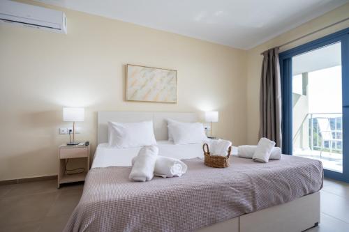a bedroom with a large bed with towels on it at La Luna Hotel in Troulos