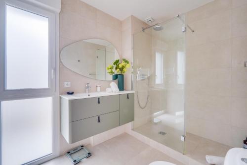 a white bathroom with a sink and a shower at La Villa Caudéran - Déco chic et bohème in Bordeaux