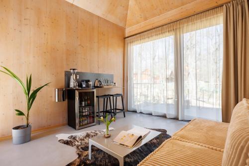 a living room with a couch and a table at Pazar Homes in Zánka
