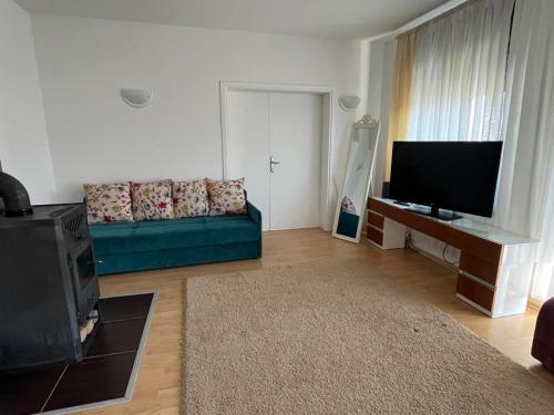 a living room with a couch and a flat screen tv at Mostarlic Motel in Raskršće