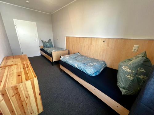 a room with two bunk beds and a table at Pension BettMan Erfurt in Erfurt