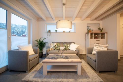 a living room with two couches and a coffee table at VechteSonne - Nordhorn in Nordhorn