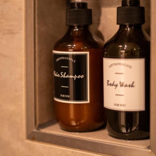 two bottles of wine sitting on a shelf at Relax Hotel & SPA Stuttgart in Stuttgart
