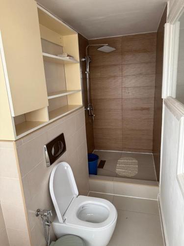 a small bathroom with a toilet and a shower at Horizon d'Ankadifotsy in Antananarivo