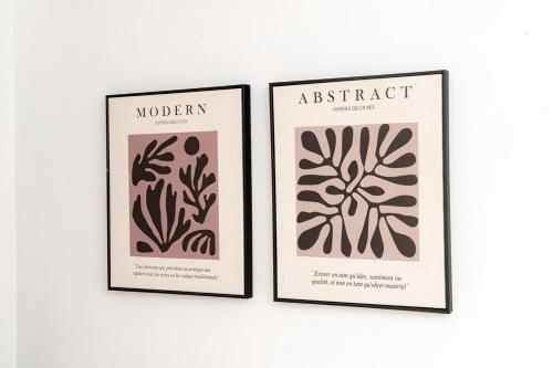 two framed prints of plants on a wall at Comfortable 3-Bed, 2-Bath Basingstoke Stay in Basingstoke