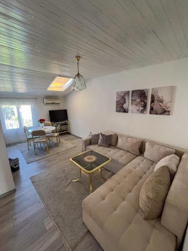 a living room with a couch and a table at Velora Apartment Mostar in Mostar