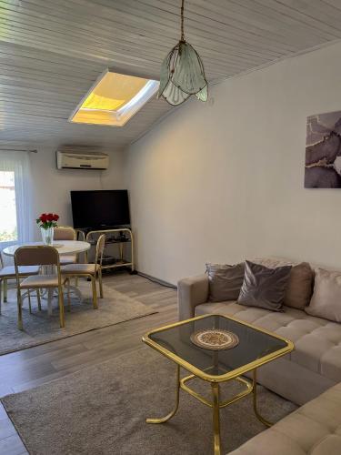 a living room with a couch and a table at Velora Apartment Mostar in Mostar