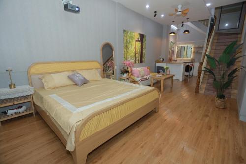 a bedroom with a bed and a living room at Na's Homestay Hải Phòng in Hai Phong