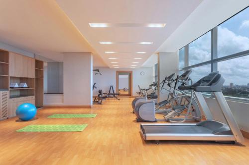 a gym with treadmills and exercise equipment in a building at Four Points by Sheraton Kochi Infopark in Cochin