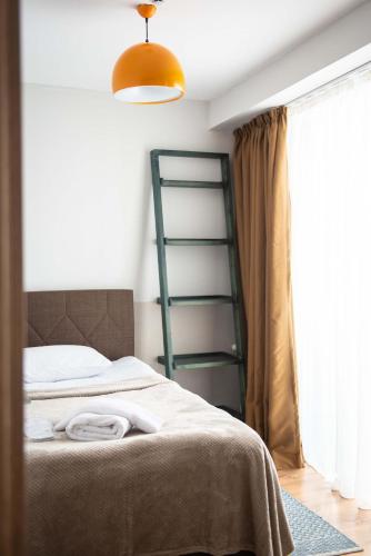 a bedroom with a bed with a green ladder at Go-Gudauri The Atrium Residence in Gudauri