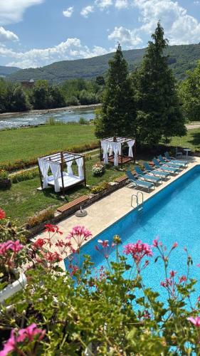 a swimming pool with chairs and a table and a wedding at Heritage Home Ustikolina in Foča
