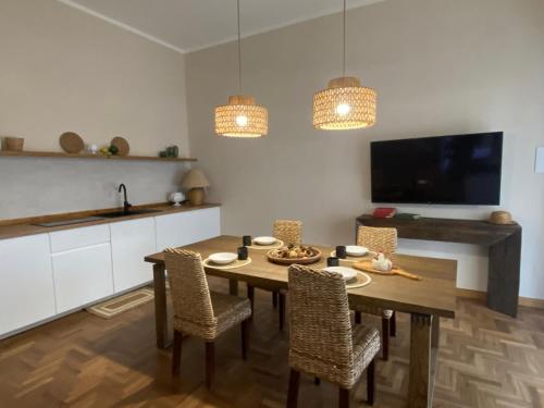 a kitchen with a table and chairs and a television at Villa Luisa Guest House in Scanzano