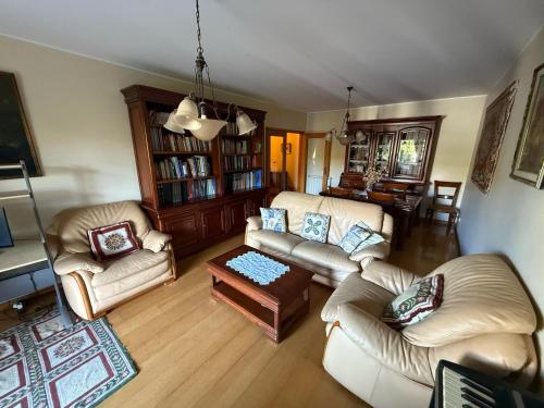 a living room with two couches and a table at Cozy and Quiet Apartment near the Center in Braga