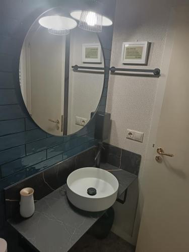 a bathroom with a white toilet and a mirror at Guest house SAL E PEDRA in Villanueva de Arosa