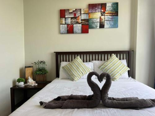 two swans made out of towels on a bed at Oceanview Condo in Boracay in Boracay