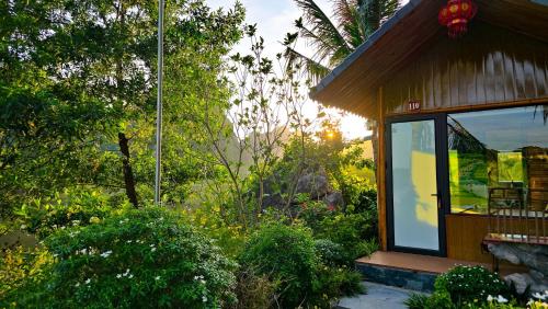 a house with a large window on the side of it at Xuan Son Lakeside Bungalow in Ninh Binh
