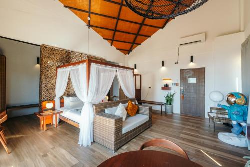 a living room with a couch and a bed at Nacpan Beach Resort Managed by H Hospitality Group in El Nido