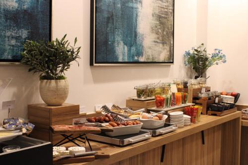 a buffet with plates of food on a table at Urban Boutique Hotel Center in Ljubljana