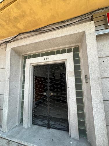 a door to a building with green tiles at Avenida House - Regina Hotel Group in Viana do Castelo