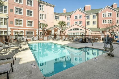 a large swimming pool in front of a building at Residence Inn by Marriott Charleston Airport in Charleston