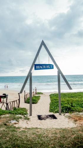 a street sign in the shape of a triangle on the beach at The Long Beach Resort & Spa in Koggala