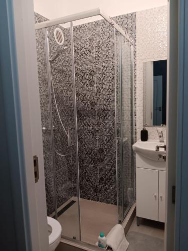 a bathroom with a shower with a toilet and a sink at Dulce Luna in Bucharest