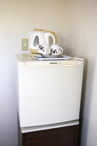 a white refrigerator with a tea set on top of it at Crane / Vacation STAY 564 in Kunisaki