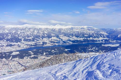 an aerial view of a snow covered mountain with a lake at 1Schönes Ferienhaus im sonnigen Kärnten in Döbriach