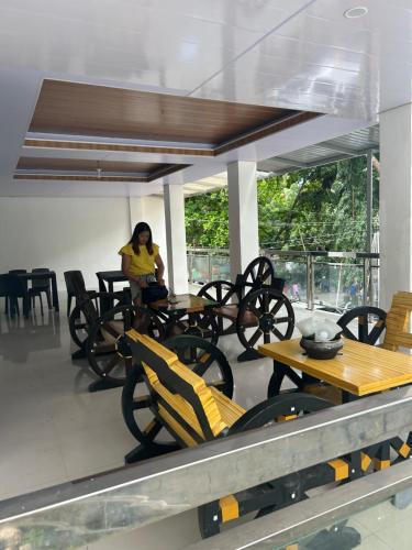 a woman sitting at a table in a restaurant at Kathy's Place at Sto Niño Cold Spring in Catarman