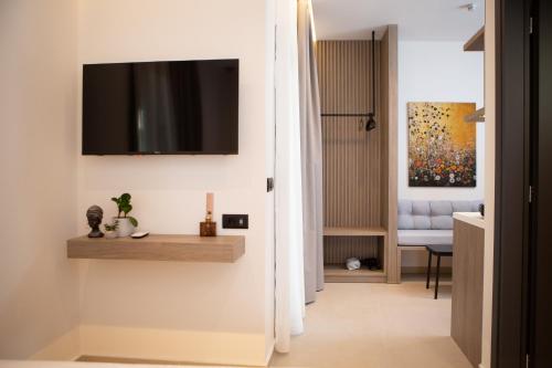 a living room with a television on a wall at Armonia Seaview Suites in Psari Forada