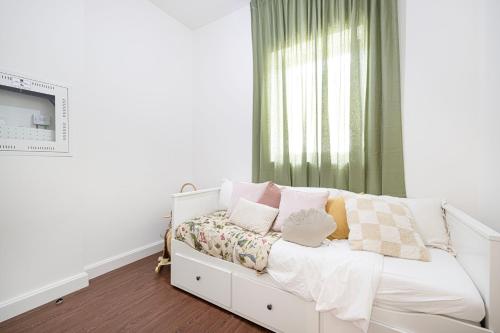 a white bed in a room with a window at Abu Dhabi 4BR Villa - Victorian-Inspired Stay in Abu Dhabi