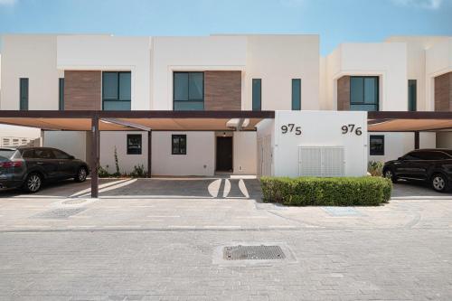 a building with cars parked in a parking lot at Abu Dhabi 4BR Villa - Victorian-Inspired Stay in Abu Dhabi