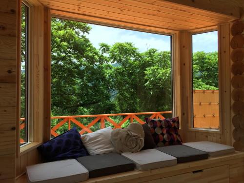 a couch in a room with a large window at Natural Retreat Mountain Blue / Vacation STAY 2336 in Hakusan