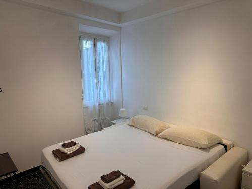 a bedroom with a bed with two towels on it at Il Poggio nel verde in Varazze