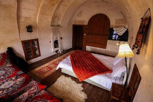 a bedroom with a large bed in a building at Katre Cave House in Ürgüp