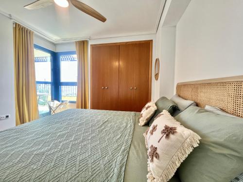 a bedroom with a bed with two pillows on it at Beachfront Family Appartment with Pool in Valencia