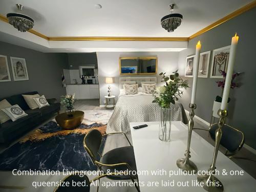 a room with a bed and a table with flowers on it at Killeröd Boutique Apartments in Båstad
