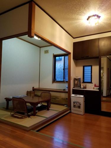 a living room with a table and a kitchen at Bibi Vacation Rental Only 2 groups per day Vacation STAY 5768 in Sakai