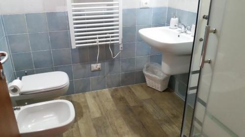 a bathroom with a toilet and a sink at B&B Maison La Coccola in Peschiera del Garda